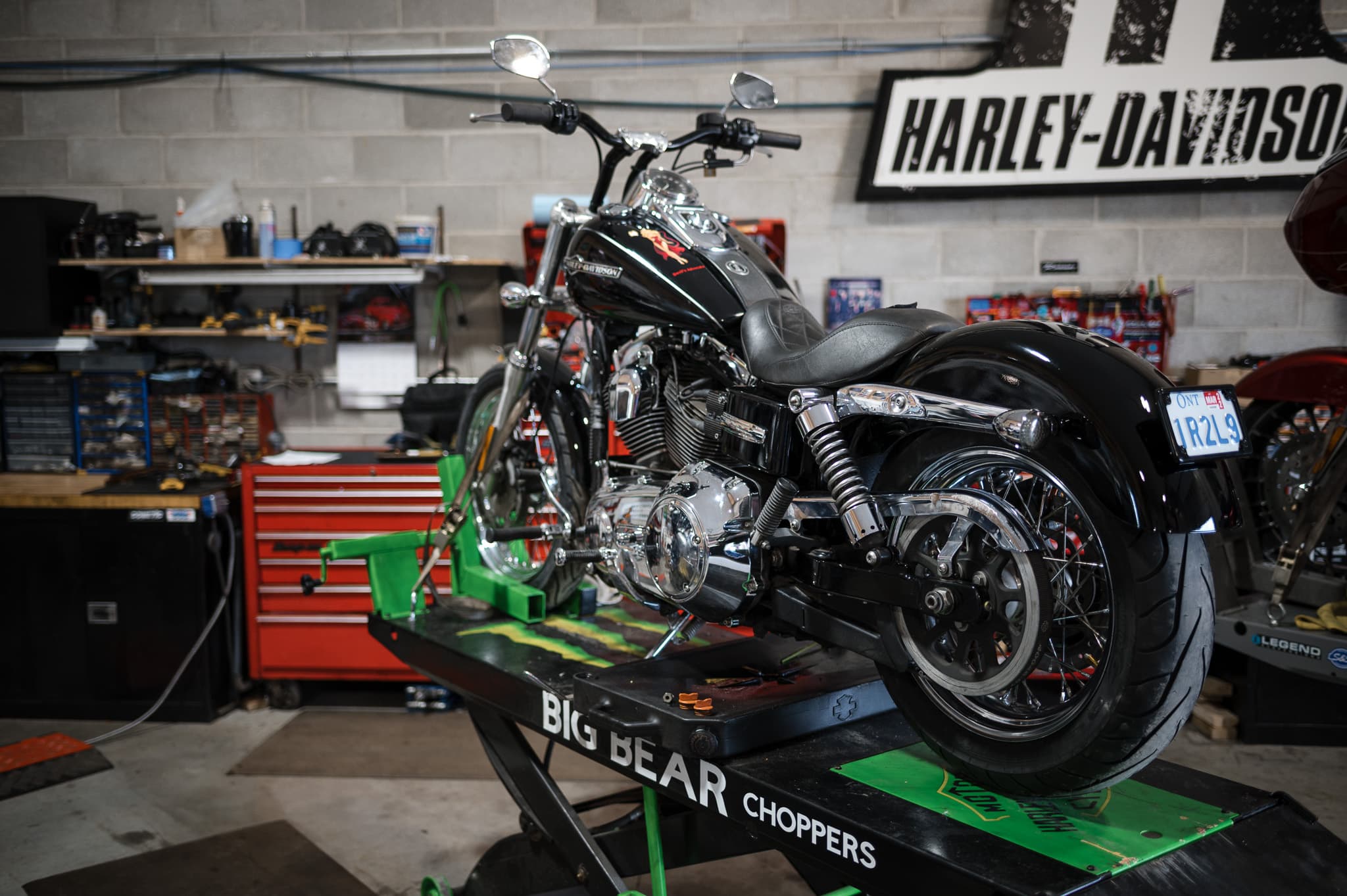 Harley up on the Big Bear lift in the DG Custom Cycle service bay