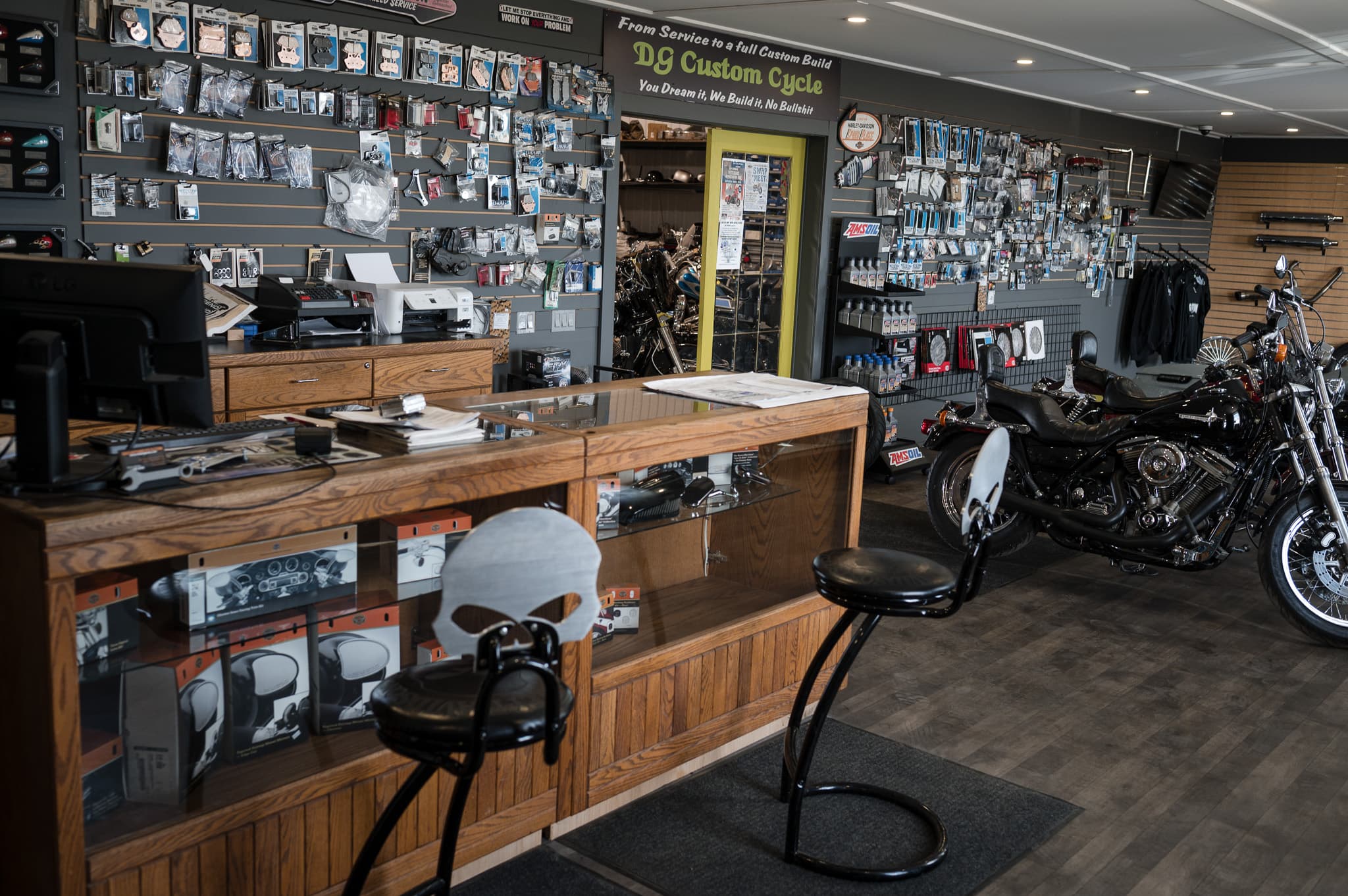 The DG Custom Cycle showroom and parts counter with a Harley on display