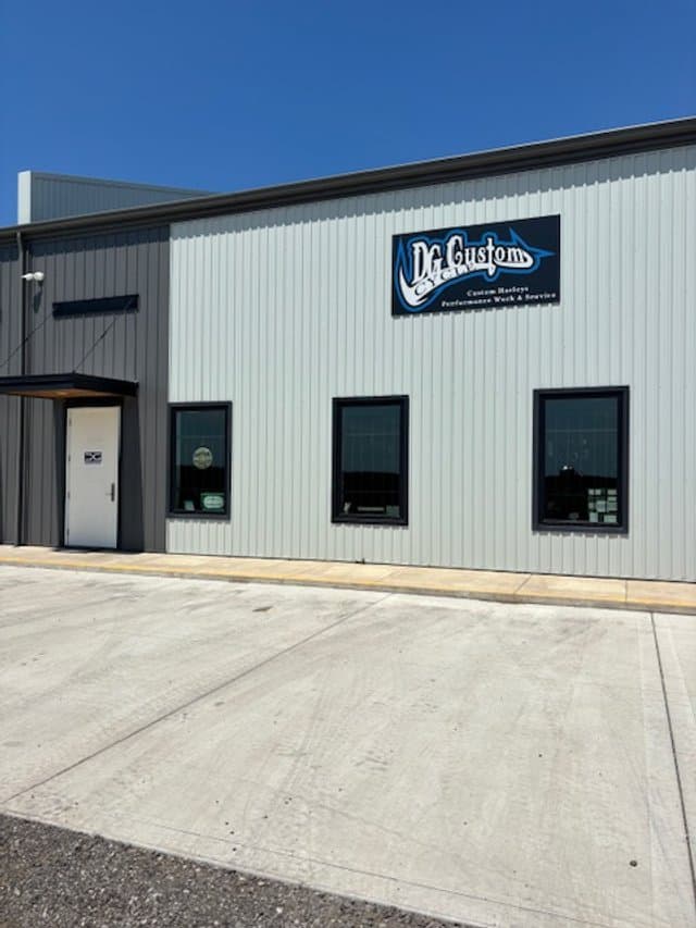 Exterior of DG Custom Cycle in Aylmer, Ontario, with the shop wordmark on the building